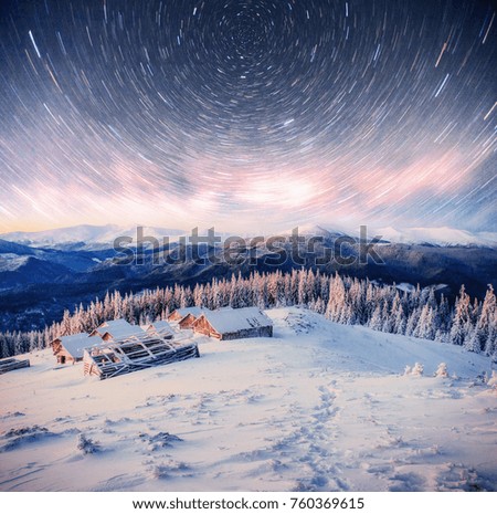 Chalets in the mountains at night under the stars. Magic event in frosty day. In anticipation of the holiday. Dramatic scenes. Carpathians Ukraine.