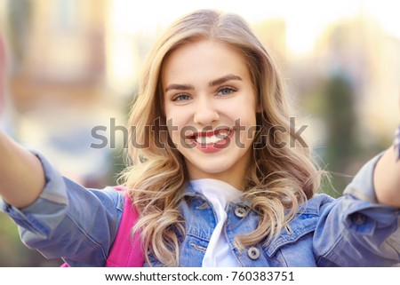 Young female tourist taking selfie outdoors