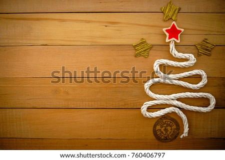 Christmas tree,star and wording merry christmas on plate with wooden background.