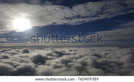 Foggy sky with cloudy sunshine took picture from airplane. 
