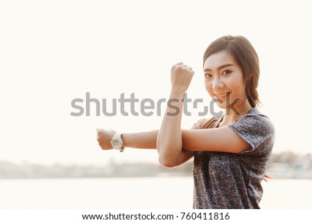Young sporty girl stretching arms