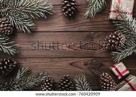 Brown wood background. Fir branches, decorative cones. Message space for Christmas and New Year. Gifts for xmas. Greeting card. Xmas and Happy New Year composition. Flat lay, top view Royalty-Free Stock Photo #760420909