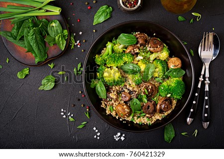 Dietary menu. Healthy vegan salad of vegetables - broccoli, mushrooms, spinach and quinoa in a bowl. Flat lay. Top view Royalty-Free Stock Photo #760421329