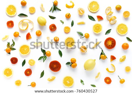 Creative flat layout of fruit, top view. Sliced orange, lemon, persimmon, tangerine, green leaves isolated on white background. Food wallpaper, composition pattern of fresh fruits. Royalty-Free Stock Photo #760430527