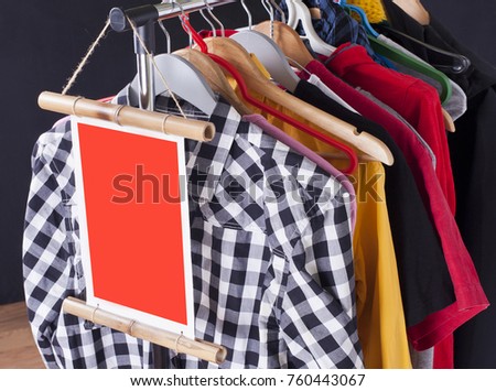 Black Friday shopping sale concept. Sale in a clothing store - discount sign at a clothes rack
