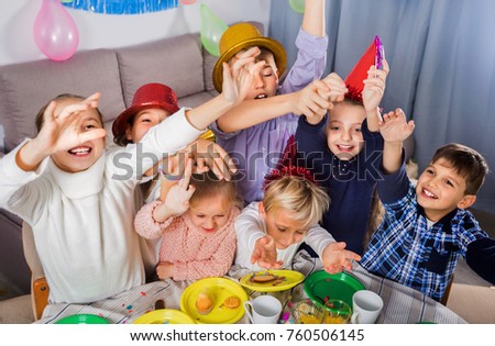 Positive smiling boys and girls behaving jokingly during friend??s birthday party