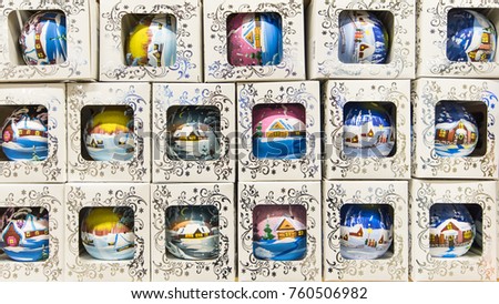 Beautiful colorful balls with a picture of winter landskape for decorating a christmas tree in a boxes with ornament