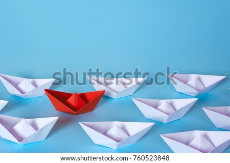 How to find the right employee in the team. White paper boats and from the midst of them stood a red. Copy space for text