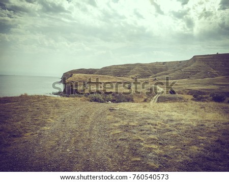 Landscape of the Crimean coast with mountains, sea, coast and trees near Karadag