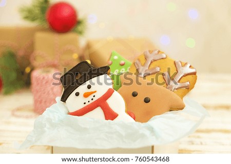 Christmas gingerbread cookies with decoration close up, christmas lights background
