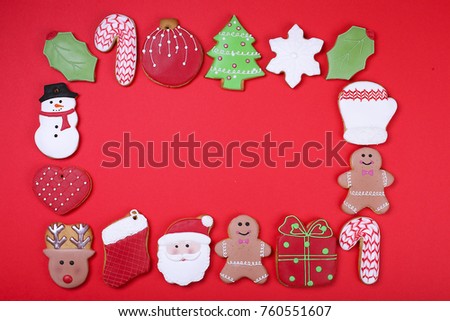 Christmas gingerbread cookies red on background top view. Christmas flat lay composition with gingerbread cookies
