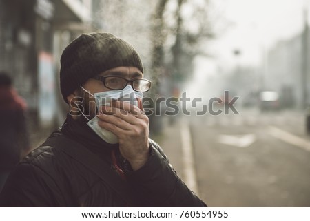 A man wearing a mask on the street. Protection against virus and grip Royalty-Free Stock Photo #760554955