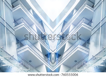 A perspective view from below of a modern building at half moon lake in ho chi minh city, vietnam, asia . v shaped, blue tone.