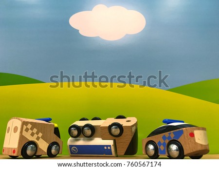 Fallen truck with oil. Traffic accident with ambulance and police car made of wood. Bright summer background