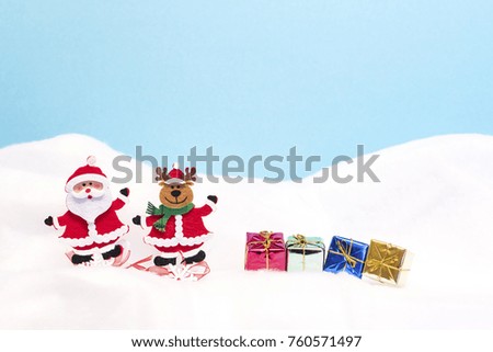 Santa and reindeer with presents in the snow