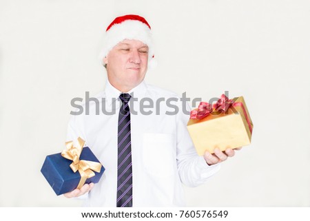 Pensive grimacing businessman choosing gift