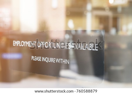 JOB OPPORTUNITIES SIGN ON SHOP GLASS WINDOW (The Image Has Shallow Depth Of Field)