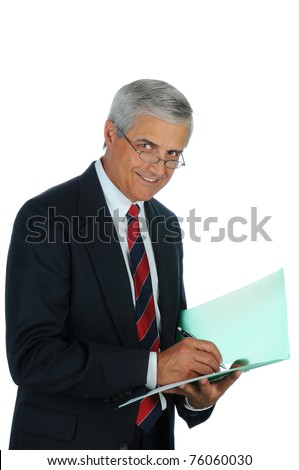 Portrait of a smiling middle aged business man writing in a file folder. Vertical format isolated on white.