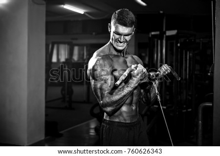 Young Handsome Bodybuilder Doing Heavy Weight Exercise For Biceps