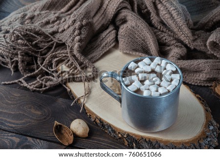 Wooden background metal mug, cacao with marshmallows