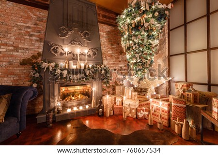 alternative tree upside down on the ceiling. Winter home decor. Modern loft interior with fireplace and brick wall Royalty-Free Stock Photo #760657534