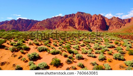 Red Mountainous Desert Landscape With Green Scrub Brush - Utah