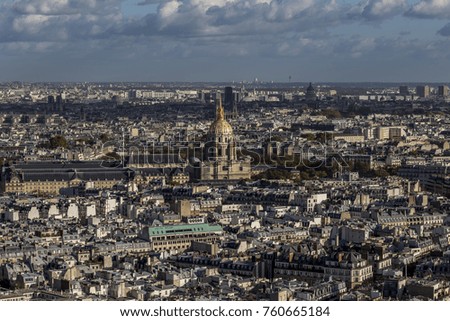 Looking out over Paris with large domed cathedral and cloudy skies