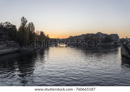 Sunrise view down the Seine river in Paris with orange sky