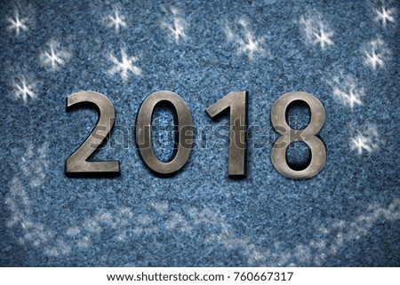 Figures of the New Year 2018 golden symbol on a granite background