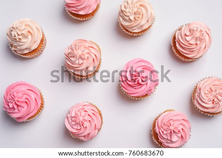 Many yummy cupcakes on white background