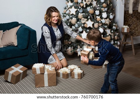 Christmas mood Mom and her son at the Christmas tree
