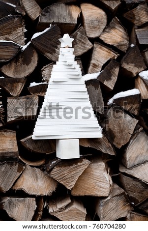 abstract white wooden christmas tree on firewood background - rustic holidays