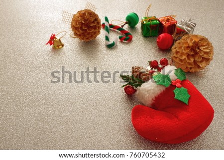 Christmas background with red sock,gift box,pine,candy on sparkling snow background  