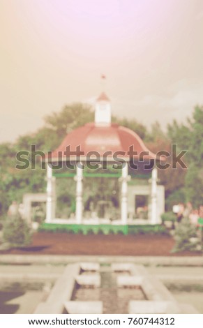 blurry picture of gazebo and flowers at park, filtered tones