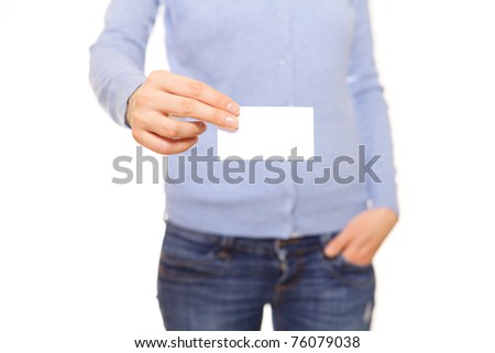 Girl wearing blue sweater and jeans handing a blank business card over white background.