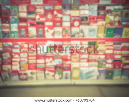 Blurred verity Christmas cards on display at retail store in America. Seasonal, greeting, holiday card for event such as Merry Christmas, Happy New Year, Happy Birthday, Anniversary Day. Vintage tone