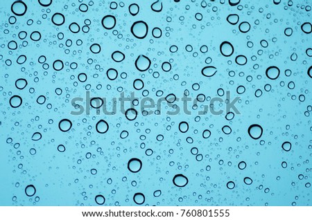 Water rain droplets or steam shower isolated on blue background.