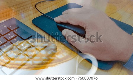 Man used computer by mouse and keyboard , double exposure with hot coffee. Work and coffee concept. 