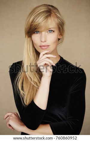 Stunning young woman in black dress, portrait Royalty-Free Stock Photo #760860952