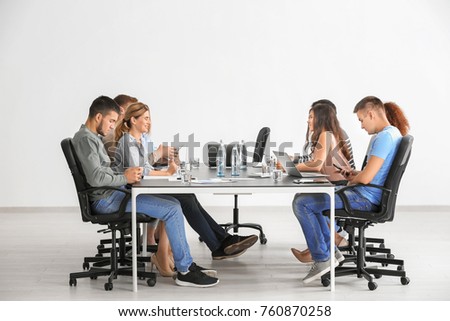 Group of people at table waiting for business trainer