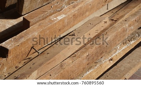 Pile of old weathered woods in worksite.