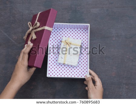 Top view children hand open gift box on wooden background