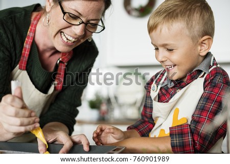 Mother and son having fun in the kitchen