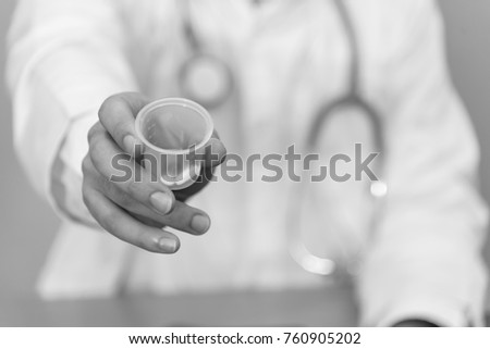 Doctor give unite dose of drugs to patient at hospital. And left hand rest on document chart.