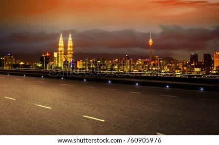 Empty asphalt road and cityscape of Kuala Lumpur night city scene