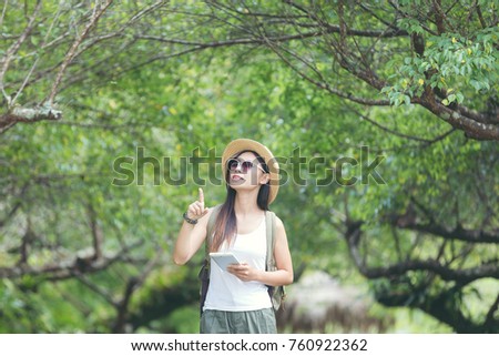 Travel happy woman tourists the on mountains on the tablet,Travel concept,Woman travel in thailand, Thailand