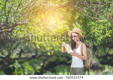 Happy female tourist to travel on atlas in hiking during vacation, Travel concept, Woman travel in thailand, Thailand