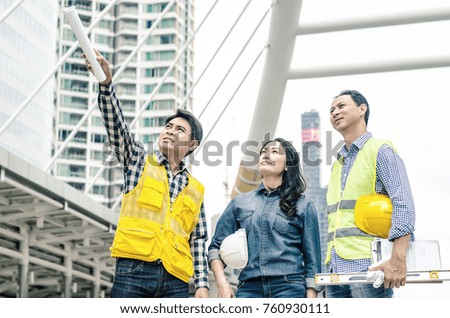 View of Three workers checking last details on a construction site