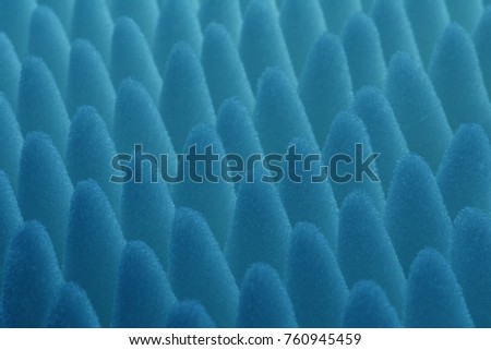 close-up of blue knolls of sponge lit by back light. Abstract macro photography of corrugated polyurethane looks like sea anemone