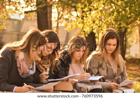 Four beautiful women signing contract outdoors